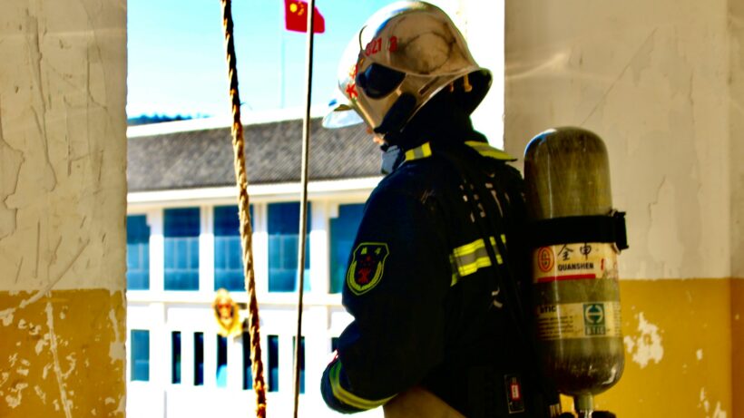 fireman using brown rope during daytime
